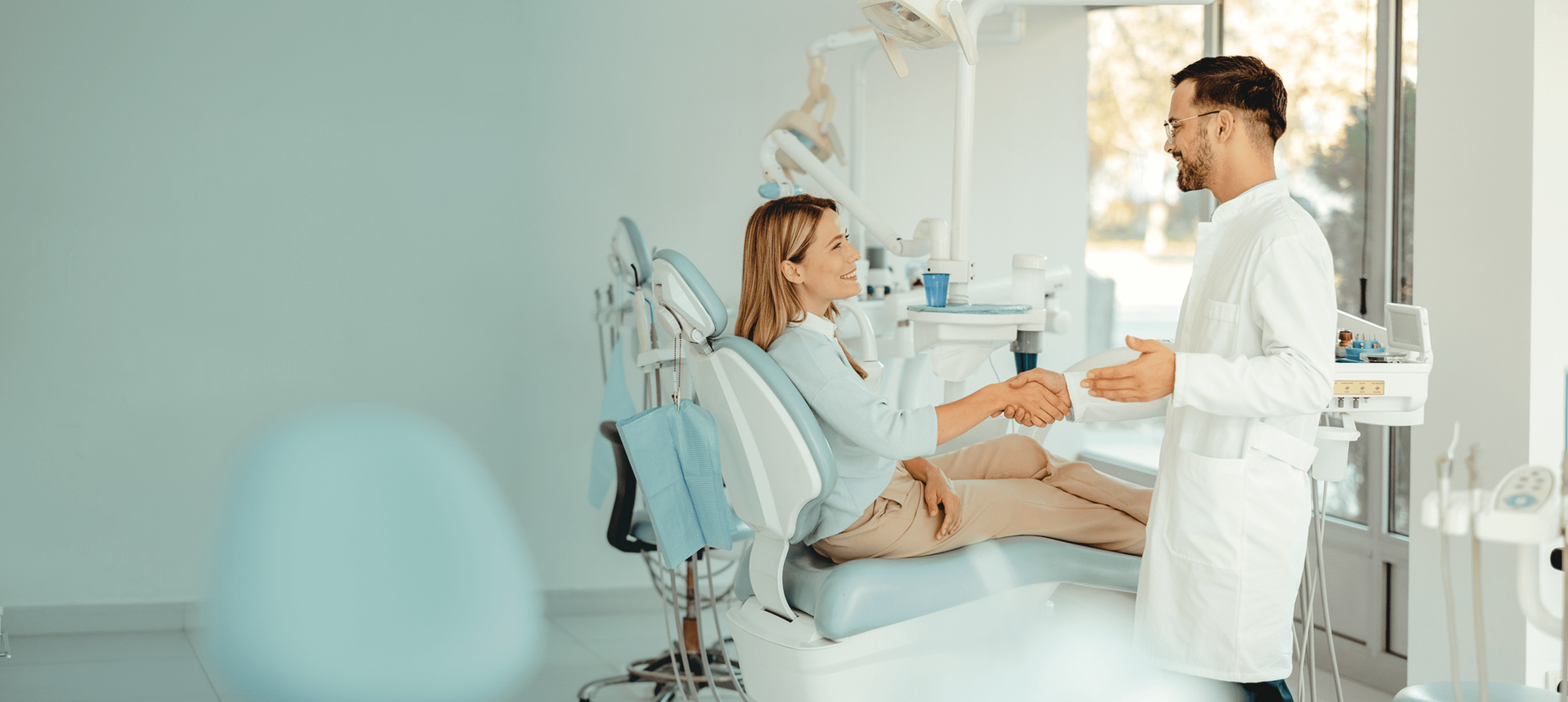 Dentist greeting patient in clinic