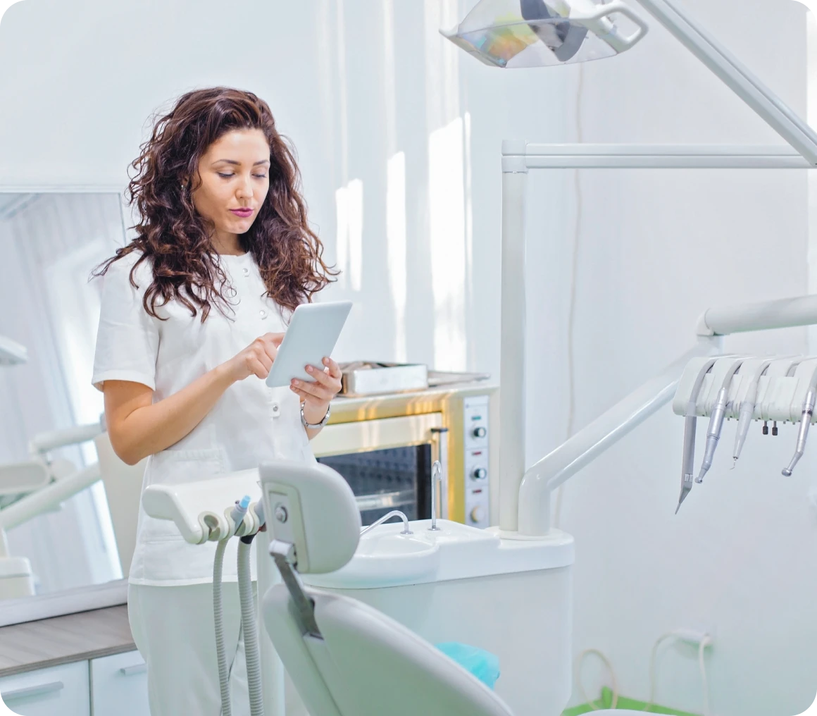 Woman dentist checking patient records