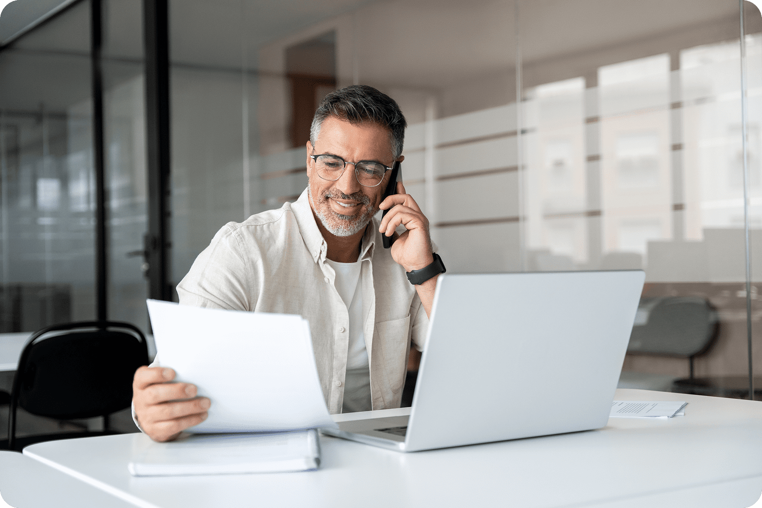 Professional in office using phone and computer