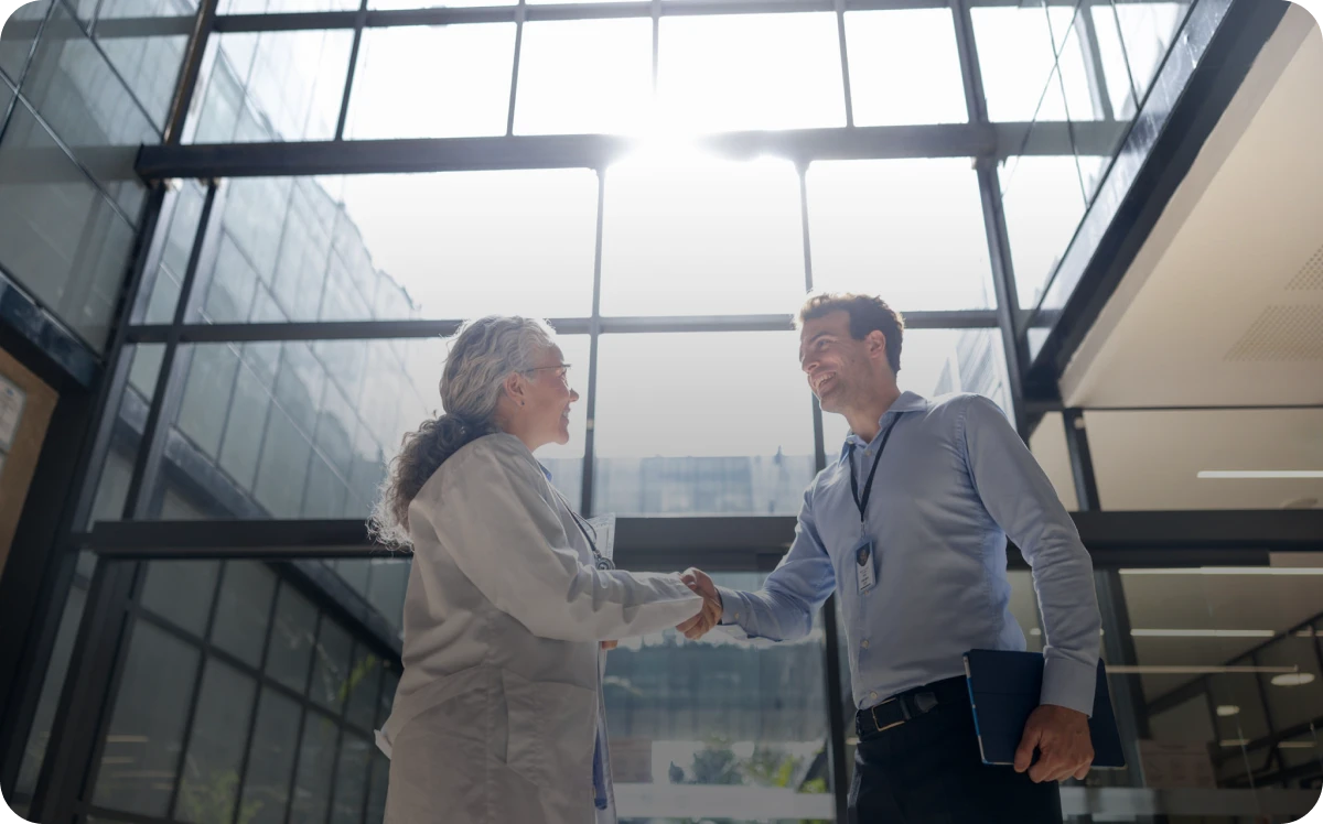 Business handshake in modern office atrium