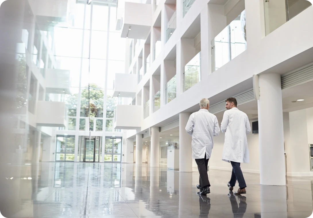 Doctors walking in modern hospital corridor