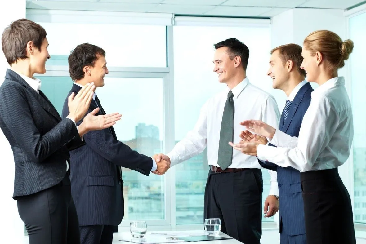 Professional team applauding handshake