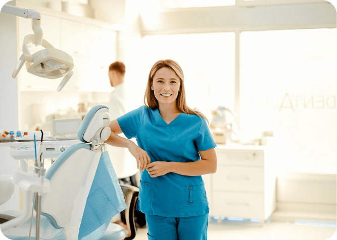 Smiling dental professional in blue scrubs