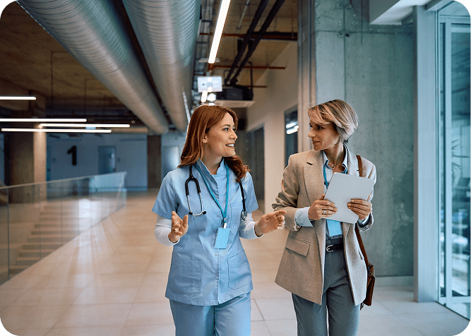 Two women discussing in hospital hallway