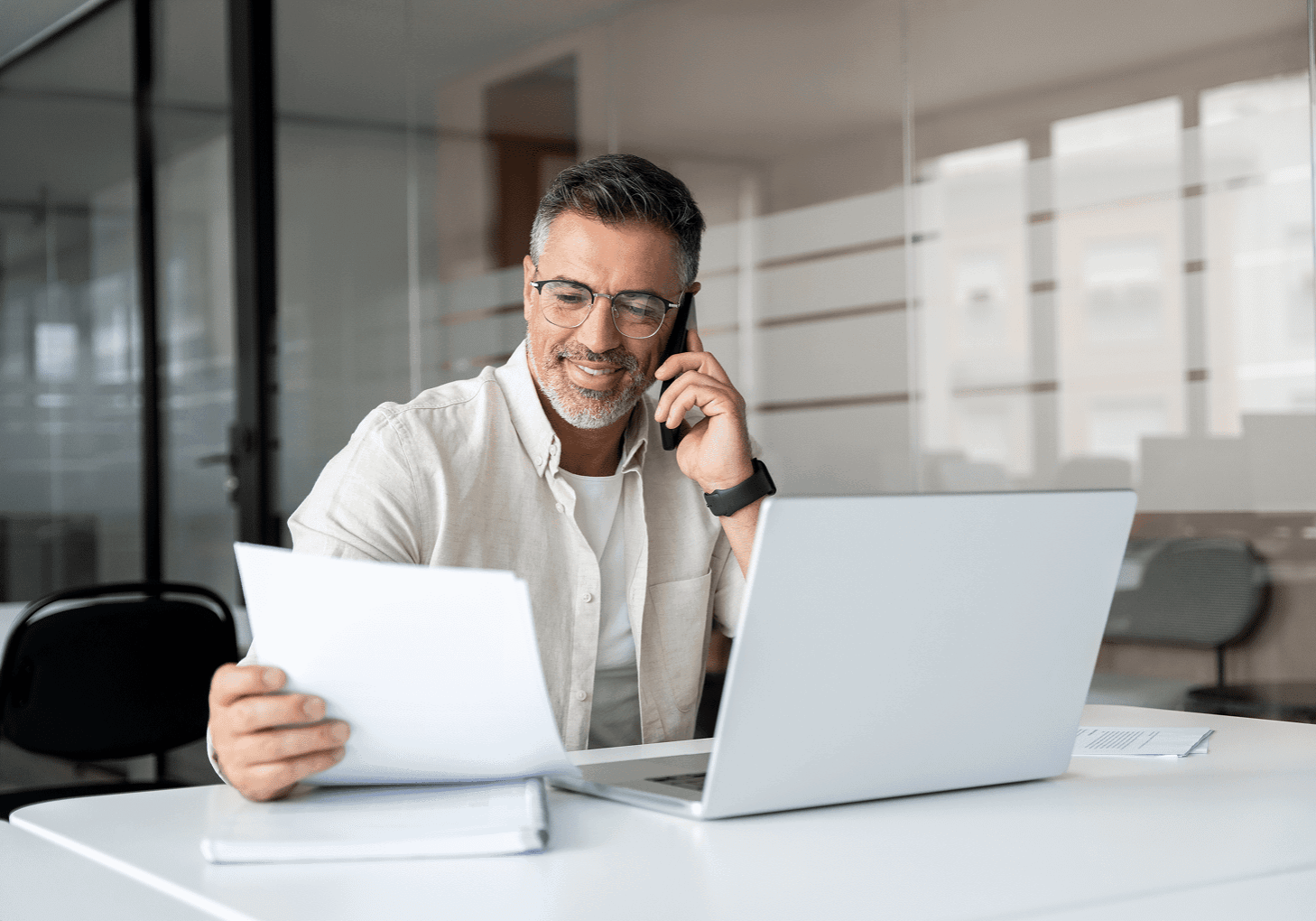 Professional in office using phone and computer