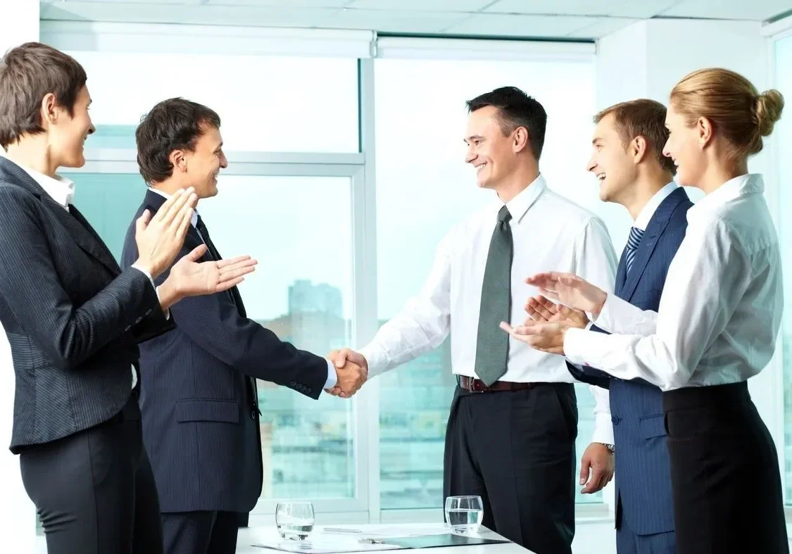 Professional team applauding handshake